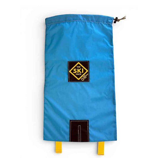 A bright blue drawstring Ski bag with a black and yellow 'The Ski Pack' logo patch on the front, featuring a top drawstring closure and yellow loops at the bottom, shown against a plain white background.
