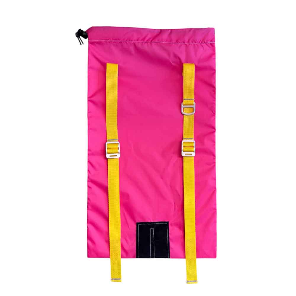 A bright pink ski backpack with two vertical yellow webbing straps and silver metal buckles, shown against a plain white background.
