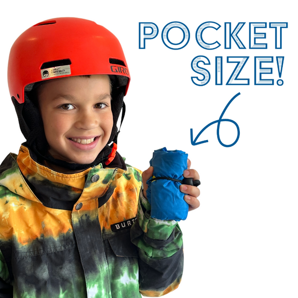 A picture of a child holding a Ski Pack showing it fits in a winter jacket.