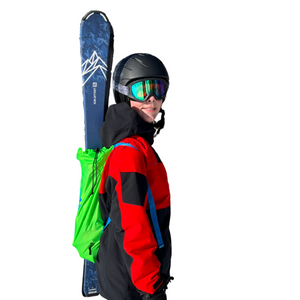 Youth wearing Green Ski Pack from a side view