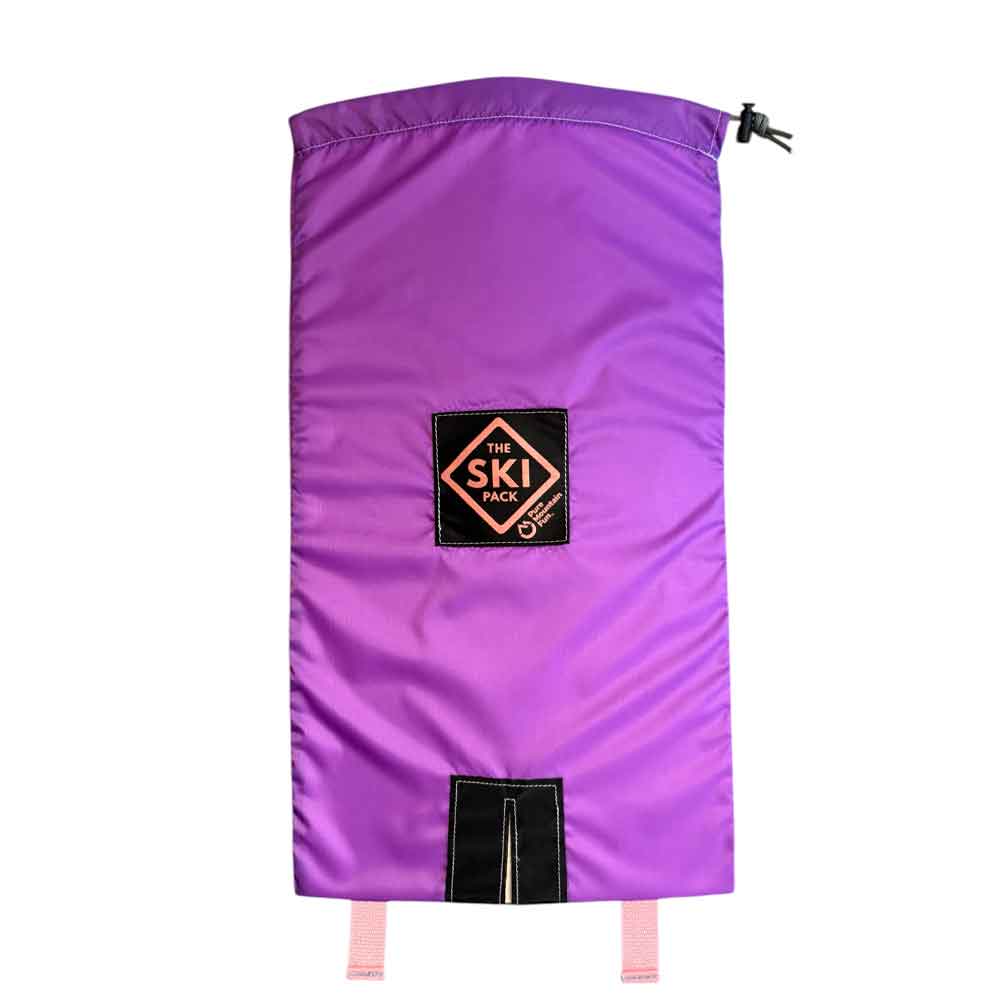 A purple ski bag with a black logo patch reading 'THE SKI CLUB' and pink drawstring ties, shown against a plain white background.