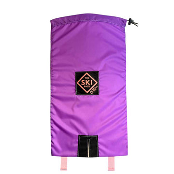 A purple ski bag with a black logo patch reading 'THE SKI CLUB' and pink drawstring ties, shown against a plain white background.