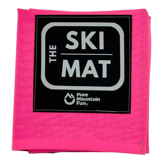 A folded hot pink ski mat with a black square patch featuring the text 'THE SKI MAT' in white and 'Pure Mountain Fun.' below it, shown on a plain white background.