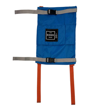 A 2026 Blue Rider Pack with Orange Straps harness-style accessory with gray webbing straps and orange vertical straps, shown on a plain white background. A black rectangular patch on the front reads 'THE RIDER PACK'.