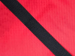 Close up of red fabric and dark navy strap