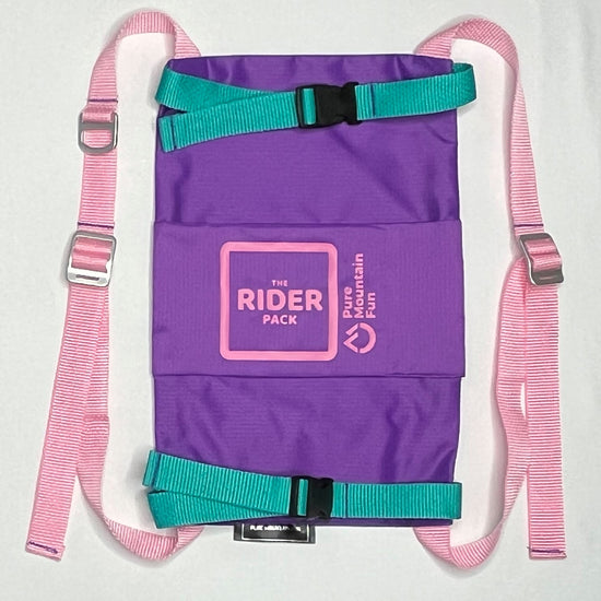 Front image of the purple Rider Pack featuring pink straps with adjusters. Teal straps go across the snowboard to hold it secure. 