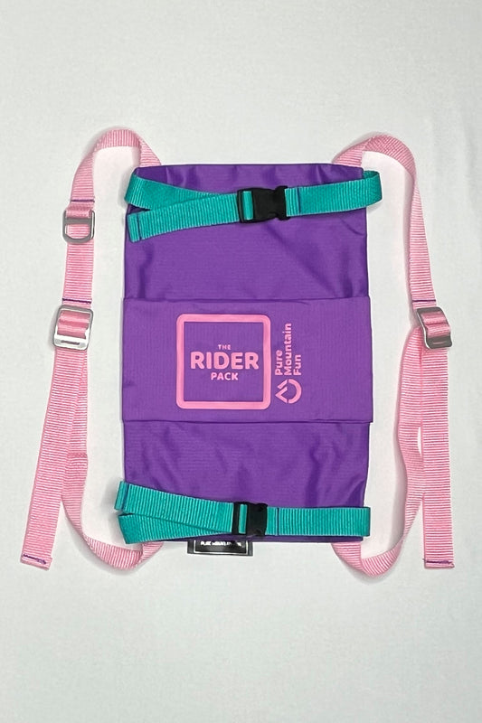 Front image of the purple Rider Pack featuring pink straps with adjusters. Teal straps go across the snowboard to hold it secure. 
